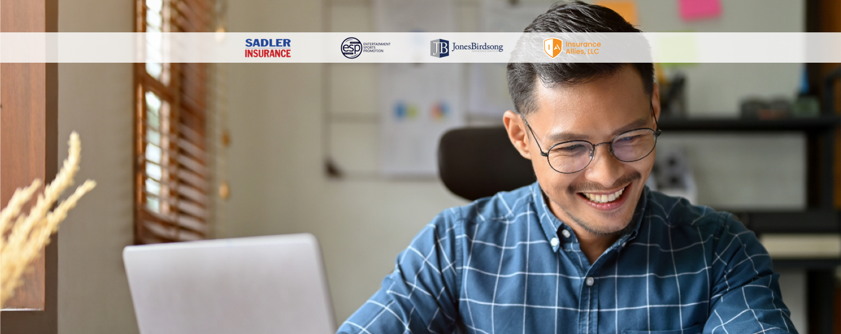 Smiling business owner working at their office desk.