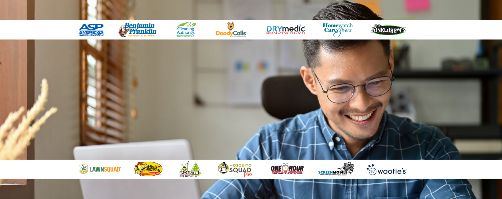 Smiling business owner working at their office desk.